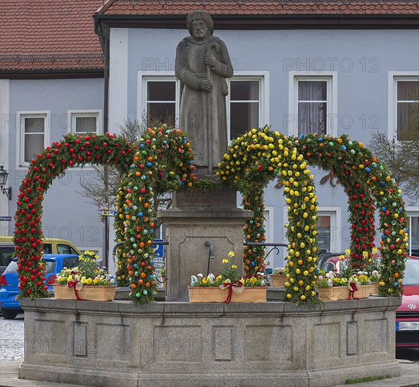 Easter fountain with fountain figure by Viktor Ueberkum, died around 1440, was a revered pilgrim, market square, Baunach, Upper Franconia, Bavaria, Germany, Europe