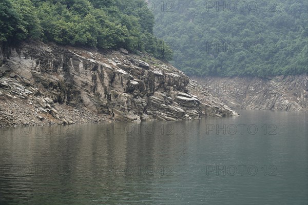 Cruise ship on the Yangtze River, Hubei Province, China, Asia, Calm river flows along a rocky coast with green vegetation, Yichang, Asia