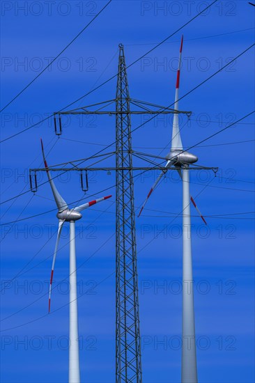 Power pylon with high-voltage lines and wind turbines at the Avacon substation Helmstedt, Helmstedt, Lower Saxony, Germany, Europe