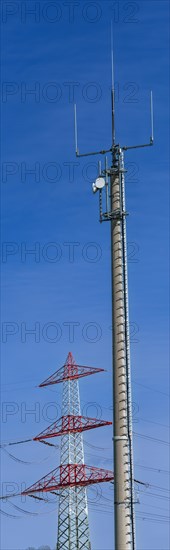 Electricity pylon with high-voltage lines and mobile phone mast near the Avacon substation Helmstedt, Helmstedt, Lower Saxony, Germany, Europe