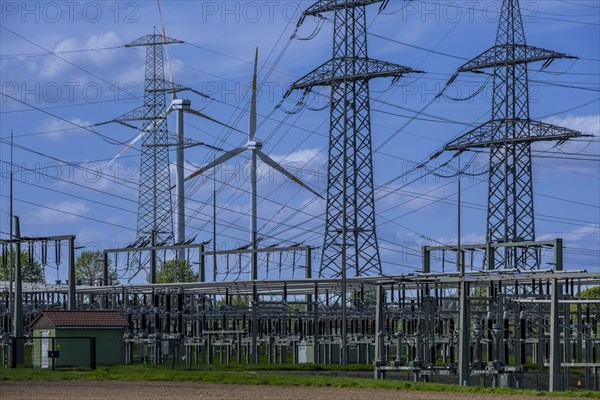 Power pylons with high-voltage lines and wind turbines at the Avacon substation in Helmstedt, Helmstedt, Lower Saxony, Germany, Europe