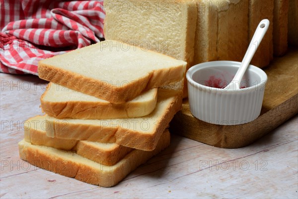 Toast, slices of toast and bowls of jam