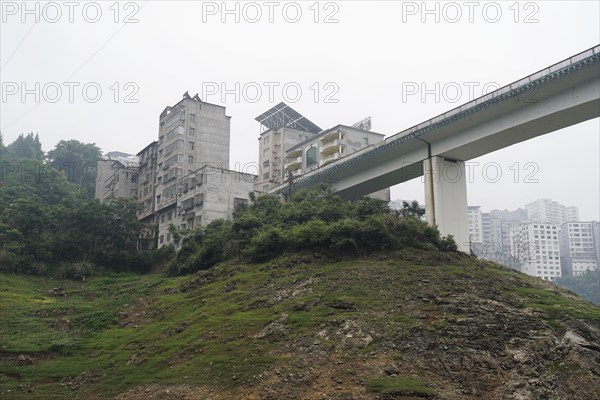 Cruise ship on the Yangtze River, Hubei Province, China, Asia, A city bridge crossing a river with surrounding mountains and skyscrapers, Yichang, Asia