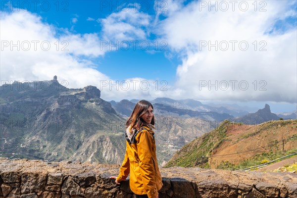 Portrait of a woman looking at Roque Nublo from a viewpoint on the mountain. Gran Canaria, Spain, Europe