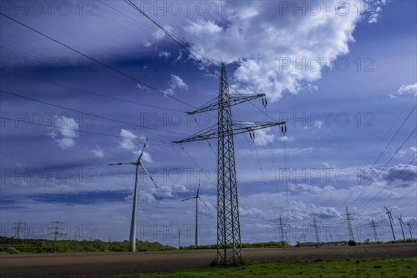 Power pylons with high-voltage lines and wind turbines at the Avacon substation in Helmstedt, Helmstedt, Lower Saxony, Germany, Europe