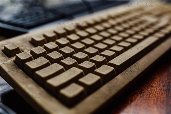 Old vintage computer mechanical keyboard in dust, computer keyboard from the 1980s