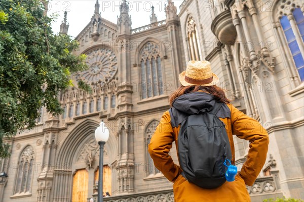 A tourist with a hat visiting the Church of San Juan Bautista, Arucas Cathedral, Gran Canaria, Spain, Europe