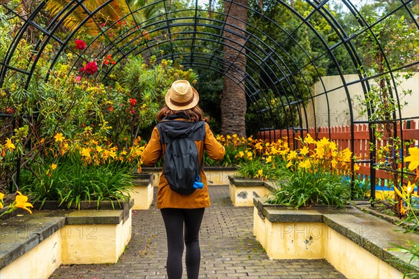 A woman walking through a beautiful botanical garden, a sustainable tourism concept in Arucas, Gran Canaria. Spain