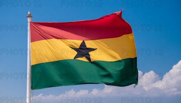 The flag of Ghana flutters in the wind, isolated against a blue sky