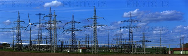 Power pylons with high-voltage lines and wind turbines at the Avacon substation in Helmstedt, Helmstedt, Lower Saxony, Germany, Europe