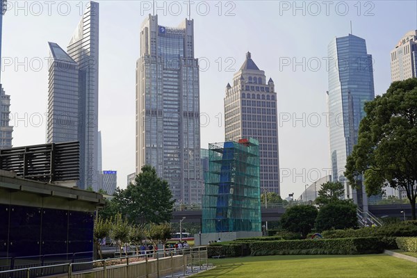 Skyscrapers of Pudong Special Economic Zone, Urban scene with skyscrapers next to green areas under a blue sky, Shanghai, China, Asia