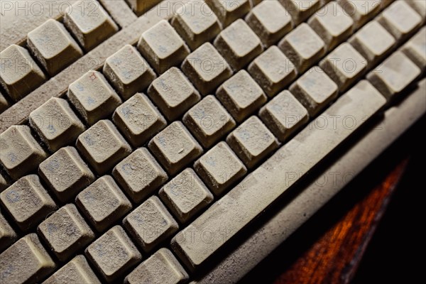 Old vintage computer mechanical keyboard in dust, computer keyboard from the 1980s