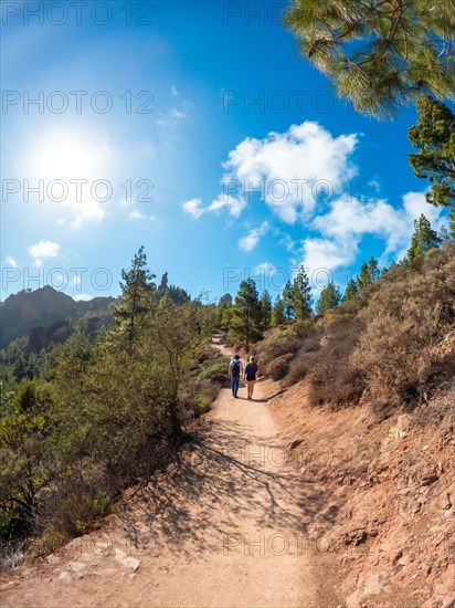 A couple of hikers on the trail up to Roque Nublo in Gran Canaria, Canary Islands