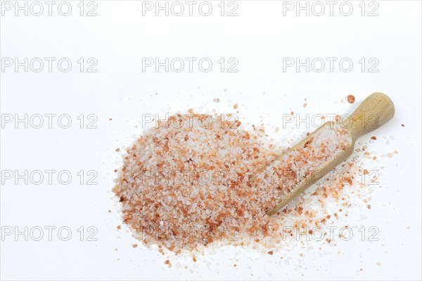 Top view of a wooden spoon with pink Himalayan salt isolated on white background and copy space