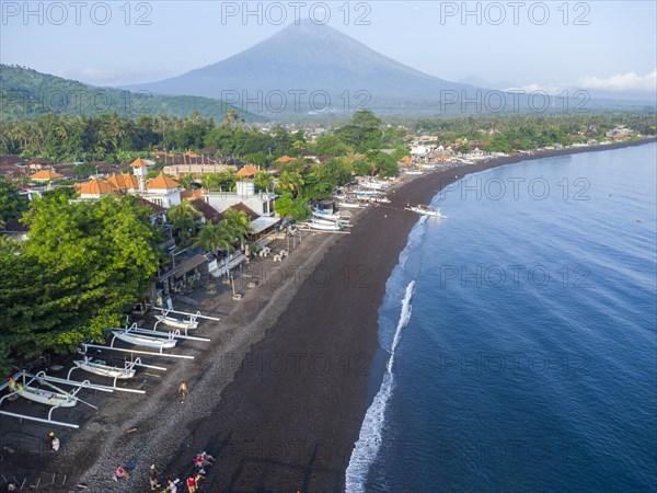 Fishermen unload their catch from their outrigger boat in the morning, in the background Gunung Agung, Amed, Karangasem, Bali, Indonesia, Asia