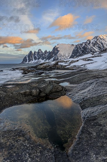 Rocky coast in front of Bergen, sea and pond, morning mood with clouds, winter, Tungeneset, Senja, Troms, Norway, Europe