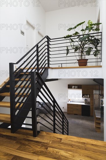 American walnut wood and black powder coated cold rolled steel stairs inside modern cube style home, Quebec, Canada, North America