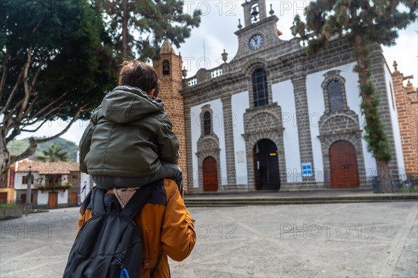 A mother with her son visiting the Basilica of Nuestra Senora del Pino in the municipality of Teror. Gran Canaria, Spain, Europe
