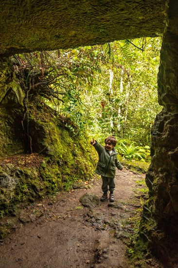 A boy in a cave in the Laurisilva forest of Los tilos de Moya, Gran Canaria