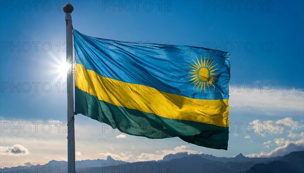 The flag of Rwanda, fluttering in the wind, isolated, against the blue sky