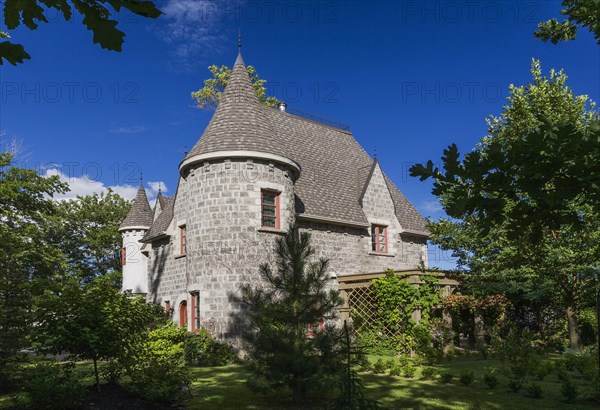2006 reproduction of a 16th century grey stone and mortar Renaissance castle style residential home facade in summer, Quebec, Canada, North America