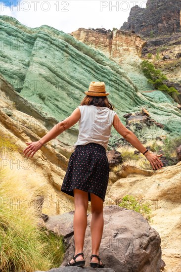 Enjoying the freedom in the natural monument at the Azulejos de Veneguera or Rainbow Rocks in Mogan, Gran Canaria