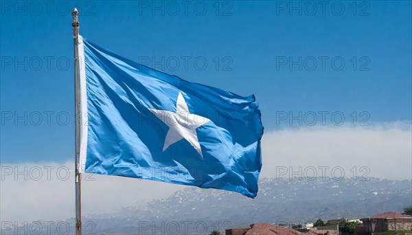 The flag of Somalia, fluttering in the wind, isolated, against the blue sky