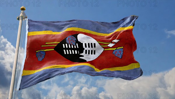 The flag of Swaziland, Kingdom of Eswatini, flutters in the wind, isolated, against the blue sky