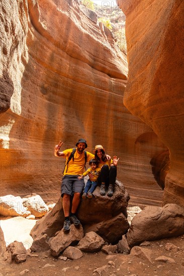 A family of tourists enjoying in the limestone canyon Barranco de las Vacas in Gran Canaria, Canary Islands
