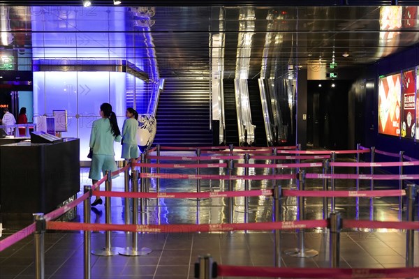 An interior with an empty queue demarcated by red delineators and shiny surfaces, Shanghai, China, Asia