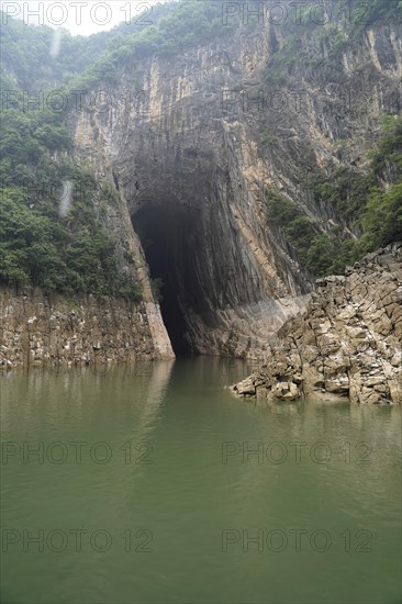 Cruise ship on the Yangtze River, Hubei Province, China, Asia, High rock walls surround a calm river under a cloudy sky, Yichang, Asia