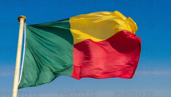 The flag of Benin flutters in the wind, isolated against the blue sky