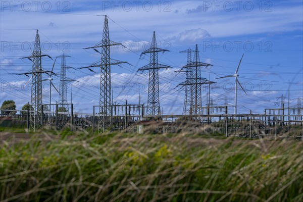 Power pylons with high-voltage lines and wind turbines at the Avacon substation in Helmstedt, Helmstedt, Lower Saxony, Germany, Europe