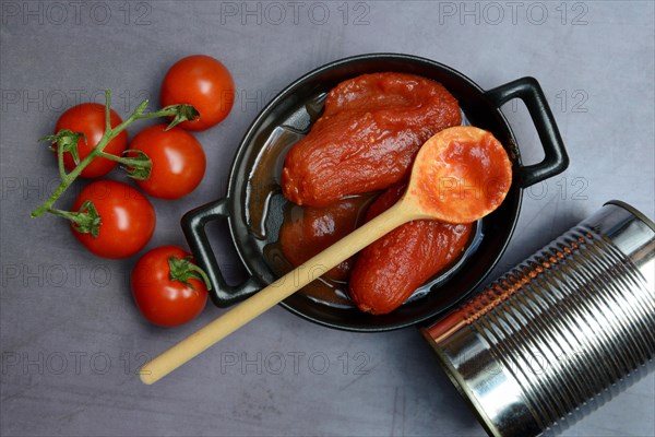 Whole tinned tomatoes in a pot, tomatoes and tins