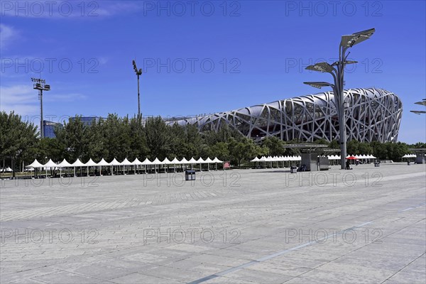 Beijing, China, Asia, Modern stadium complex seen from the spacious, empty forecourt on a sunny day, Asia