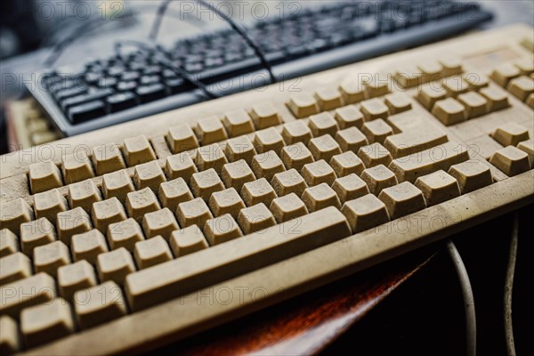 Old vintage computer mechanical keyboard in dust, computer keyboard from the 1980s