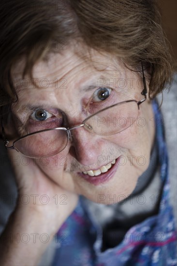 Senior citizen supports her head in her hand, portrait, Cologne, North Rhine-Westphalia, Germany, Europe