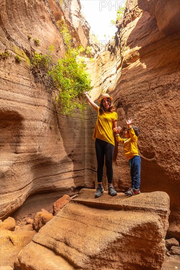 Family on vacation enjoying in the limestone canyon Barranco de las Vacas in Gran Canaria, Canary Islands