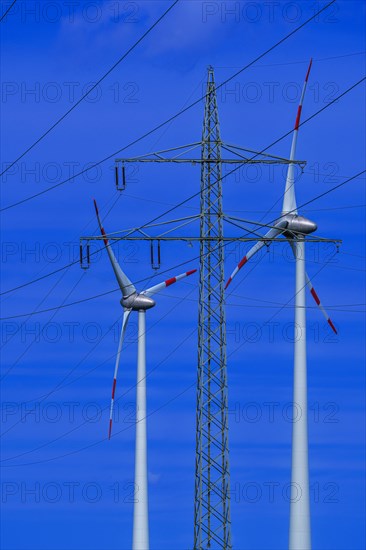 Power pylon with high-voltage lines and wind turbines at the Avacon substation Helmstedt, Helmstedt, Lower Saxony, Germany, Europe