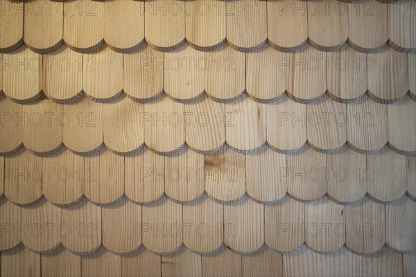 Wooden shingles are arranged like fish scales, surface, pattern and background