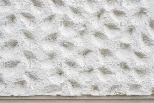 Roughly patterned plastered wall in detail, background and structure