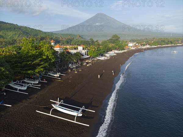 Fishermen loading fish from their outrigger boats in the morning on the black beach of Amed, Amed, Karangasem, Bali, Indonesia, Asia
