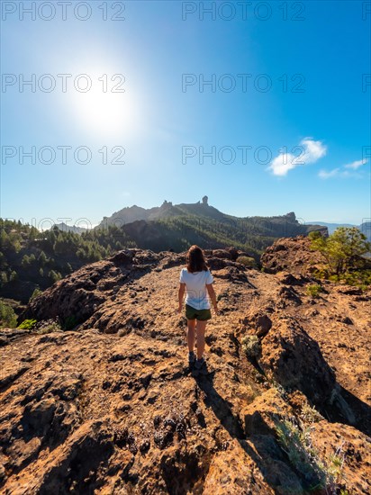 A woman hiker at a viewpoint of Roque Nublo in Gran Canaria, Canary Islands