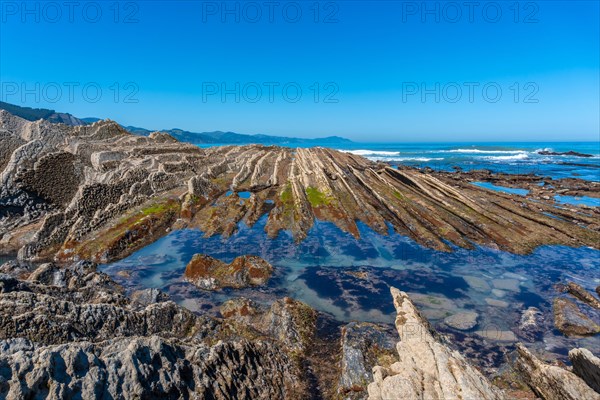 Beautiful landscape of the Flysch Basque Coast geopark in Zumaia with low seas, Gipuzkoa