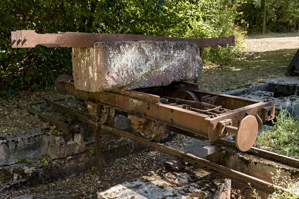 Rusty wagon, wagon on rail with block of Michelnau tuff, red basalt, red lava, slag agglomerate, disused Michelnau quarry, Tertiary volcano, geotope, industrial monument, Michelnau, Vogelsberg Volcanic Region nature park Park, Nidda, Wetterau, Hesse, Germany, Europe