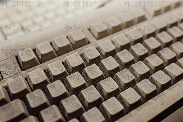 Old vintage computer mechanical keyboard in dust, computer keyboard from the 1980s