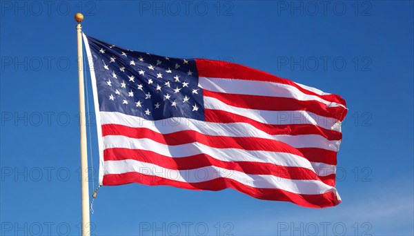The flag of USA, America, United States, fluttering in the wind, isolated against a blue sky, North America