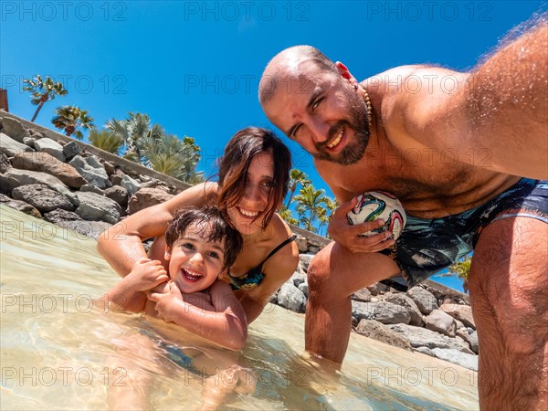 A family on vacation on a beach in the Canary Islands. Concept of happy family outdoors. Family vacation on the sea coast