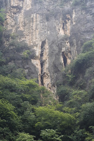 Cruise ship on the Yangtze River, Hubei Province, China, Asia, Rocky natural scenery with a large cave and surrounding green vegetation, Yichang, Asia