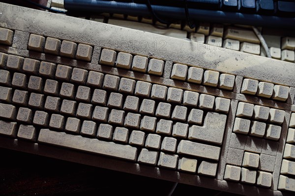 Old vintage computer mechanical keyboard in dust, computer keyboard from the 1980s